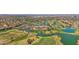 An elevated view featuring a golf course with lush greenery, serene lakes, and a clubhouse with a parking lot at 3800 S Cantabria Cir # 1077, Chandler, AZ 85248