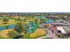 An aerial view showcasing a golf course clubhouse with water features, lush greenery, and manicured landscapes at 3800 S Cantabria Cir # 1077, Chandler, AZ 85248