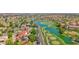 Stunning aerial view of a golf course community with lush landscaping, serene lakes, and beautiful homes at 3800 S Cantabria Cir # 1077, Chandler, AZ 85248