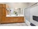 Bright bathroom featuring double sinks, modern lighting, and a clean shower-tub with sliding glass doors at 3800 S Cantabria Cir # 1077, Chandler, AZ 85248