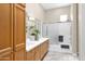 Well-lit bathroom showcasing a double vanity with stylish mirrors and a shower-tub combo at 3800 S Cantabria Cir # 1077, Chandler, AZ 85248