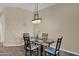 Dining area with modern chandelier and glass-topped table with carpet flooring at 3800 S Cantabria Cir # 1077, Chandler, AZ 85248