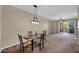 Dining area featuring modern chandelier and access to the balcony with sliding doors for natural light at 3800 S Cantabria Cir # 1077, Chandler, AZ 85248