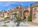 Attractive townhome featuring a covered entryway, garage, and lush landscaping for curb appeal at 3800 S Cantabria Cir # 1077, Chandler, AZ 85248