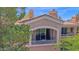 A view of a beautiful multi-story home showcasing its upper-level window with decorative balcony railing at 3800 S Cantabria Cir # 1077, Chandler, AZ 85248