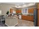 Bright and open kitchen boasts a breakfast bar with granite counter top and tile floors at 3800 S Cantabria Cir # 1077, Chandler, AZ 85248