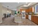 Bright kitchen features wooden cabinets, granite countertops, and an eat-in island, and access to the dining room at 3800 S Cantabria Cir # 1077, Chandler, AZ 85248