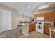 Warm neutral kitchen features light wood cabinetry, granite counters, and a central island for seating at 3800 S Cantabria Cir # 1077, Chandler, AZ 85248
