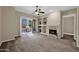 Spacious living room featuring sliding glass doors to balcony and stone fireplace with built in shelves at 3800 S Cantabria Cir # 1077, Chandler, AZ 85248