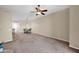 Carpeted living room featuring ceiling fan and access to dining room at 3800 S Cantabria Cir # 1077, Chandler, AZ 85248