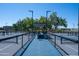 Outdoor pickleball courts featuring blue playing surfaces, shaded benches, and well-maintained surroundings at 3800 S Cantabria Cir # 1077, Chandler, AZ 85248