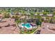 Aerial view of a sparkling community pool and hot tub amidst lush landscaping and luxurious homes at 3800 S Cantabria Cir # 1077, Chandler, AZ 85248