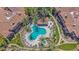 Aerial shot showcasing the community pool with inviting turquoise waters and palm tree landscaping at 3800 S Cantabria Cir # 1077, Chandler, AZ 85248