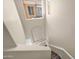 Unique view down a staircase with neutral walls and natural light, showcasing the home's architecture at 3800 S Cantabria Cir # 1077, Chandler, AZ 85248