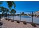 Well-maintained tennis court with a blue playing surface, surrounded by a black fence and landscaped grounds at 3800 S Cantabria Cir # 1077, Chandler, AZ 85248