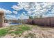 Backyard features refreshing pool, block fence and ample space for outdoor activities at 408 N Falcon Ct, Gilbert, AZ 85234