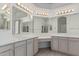 Bathroom featuring tile flooring, double sinks, large mirrors, and vanity area at 408 N Falcon Ct, Gilbert, AZ 85234
