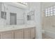 Bright bathroom featuring double sink vanity, updated fixtures, and a shower-tub combination at 408 N Falcon Ct, Gilbert, AZ 85234