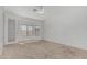 Bright bedroom featuring neutral carpet, ceiling fan, and natural light through large windows at 408 N Falcon Ct, Gilbert, AZ 85234