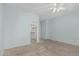 Bedroom with light-blue walls, neutral carpet, ceiling fan and a walk-in closet at 408 N Falcon Ct, Gilbert, AZ 85234
