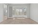 Bright bedroom with neutral carpet, sunny bay windows, and access to outdoor patio at 408 N Falcon Ct, Gilbert, AZ 85234