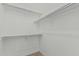 Walk-in closet with carpeted floors and custom shelving offering ample storage space at 408 N Falcon Ct, Gilbert, AZ 85234