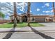 Charming single-story home featuring a well-maintained lawn and desert landscaping at 408 N Falcon Ct, Gilbert, AZ 85234