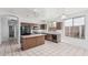 Well-lit kitchen with tile flooring, black appliances, and center island at 408 N Falcon Ct, Gilbert, AZ 85234