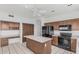Well-lit kitchen with tile flooring, black appliances, and center island at 408 N Falcon Ct, Gilbert, AZ 85234