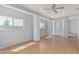 Bright living room features hardwood floors, ample natural light, and a ceiling fan at 408 N Falcon Ct, Gilbert, AZ 85234
