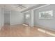 Spacious living room with hardwood floors, ample natural light, and a ceiling fan at 408 N Falcon Ct, Gilbert, AZ 85234
