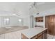 Open-concept living space with tile floors and kitchen island at 408 N Falcon Ct, Gilbert, AZ 85234