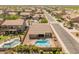 Scenic aerial view of home with inviting backyard pool and spa, situated in a quiet neighborhood at 44574 W High Desert Trl, Maricopa, AZ 85139