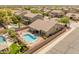 Stunning aerial view of home with pool, spa, and fire pit in a well-maintained neighborhood at 44574 W High Desert Trl, Maricopa, AZ 85139