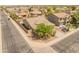 Birds-eye view of a cozy home with a two-car garage, desert landscaping, situated in a quiet residential neighborhood at 44574 W High Desert Trl, Maricopa, AZ 85139