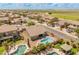 Expansive aerial view of home with a beautiful pool and serene neighborhood, near agricultural land at 44574 W High Desert Trl, Maricopa, AZ 85139