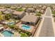 Aerial view of home with luxurious pool, spa, and outdoor entertaining area in a residential neighborhood at 44574 W High Desert Trl, Maricopa, AZ 85139