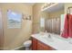 Well-lit bathroom with a vanity, toilet, and shower/tub combination creating a functional space at 44574 W High Desert Trl, Maricopa, AZ 85139