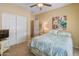 Comfortable bedroom featuring a ceiling fan, closet and natural light, offering a cozy retreat at 44574 W High Desert Trl, Maricopa, AZ 85139