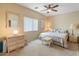Inviting bedroom with wicker furniture, soft colors and natural light offering a peaceful atmosphere at 44574 W High Desert Trl, Maricopa, AZ 85139