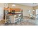 Stylish kitchen and dining area features a breakfast bar and seamless flow to the dining area at 44574 W High Desert Trl, Maricopa, AZ 85139