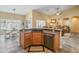 Open kitchen featuring granite countertops, stainless steel appliances, and a convenient breakfast bar at 44574 W High Desert Trl, Maricopa, AZ 85139