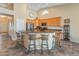 Stylish kitchen boasts a breakfast bar with seating and modern appliances at 44574 W High Desert Trl, Maricopa, AZ 85139