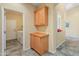 Convenient laundry area with ample cabinetry and a doorway leading to the washer and dryer at 44574 W High Desert Trl, Maricopa, AZ 85139