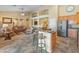 Stylish open concept living space boasts a large island separating the kitchen from the living room at 44574 W High Desert Trl, Maricopa, AZ 85139