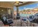 Inviting patio area with comfortable seating and picturesque views of the sparkling pool and backyard oasis at 44574 W High Desert Trl, Maricopa, AZ 85139
