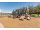 Brightly colored community playground with slides, climbing area, and shade trees at 44574 W High Desert Trl, Maricopa, AZ 85139