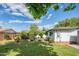 Expansive backyard with lush green grass, mature trees, and a covered patio, ideal for outdoor enjoyment at 4502 N 17Th Ave, Phoenix, AZ 85015