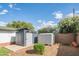 Backyard featuring outdoor storage sheds, well-maintained landscaping, and a small patio at 4502 N 17Th Ave, Phoenix, AZ 85015