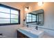 Stylish bathroom featuring a double sink vanity, black framed mirror, and subway tile walls at 4502 N 17Th Ave, Phoenix, AZ 85015